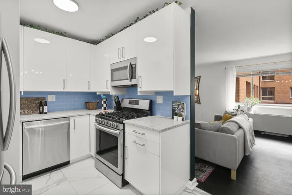 a kitchen with stainless steel appliances granite countertop a stove and a refrigerator