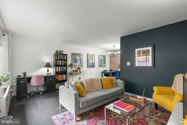 a living room with furniture and a book shelf