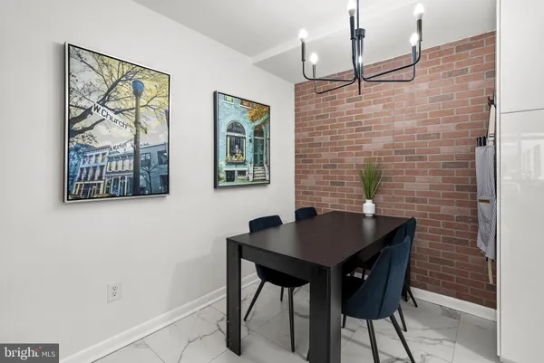 a view of a dining room with furniture a chandelier and wooden floor