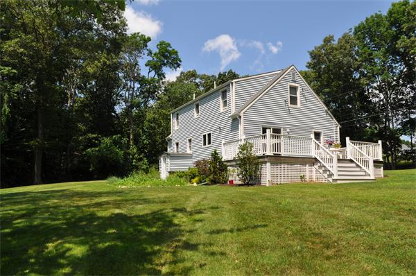 20 Frankland Road Ashland, MA 01721 - Photo 21 of 22 a front view of house with yard and trees in the background