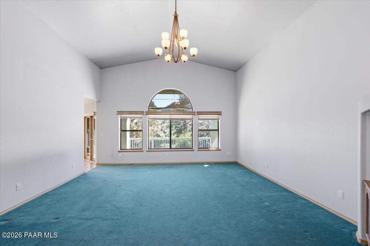 2101 Meander Prescott, AZ 86305 - Photo 3 of 22 an empty room with windows chandelier and wooden floor