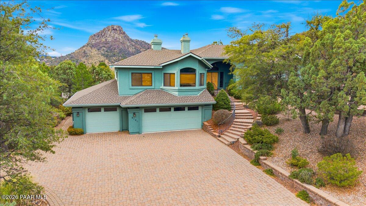 2101 Meander Prescott, AZ 86305 - Photo 3 of 9 a front view of a house with a garden and plants