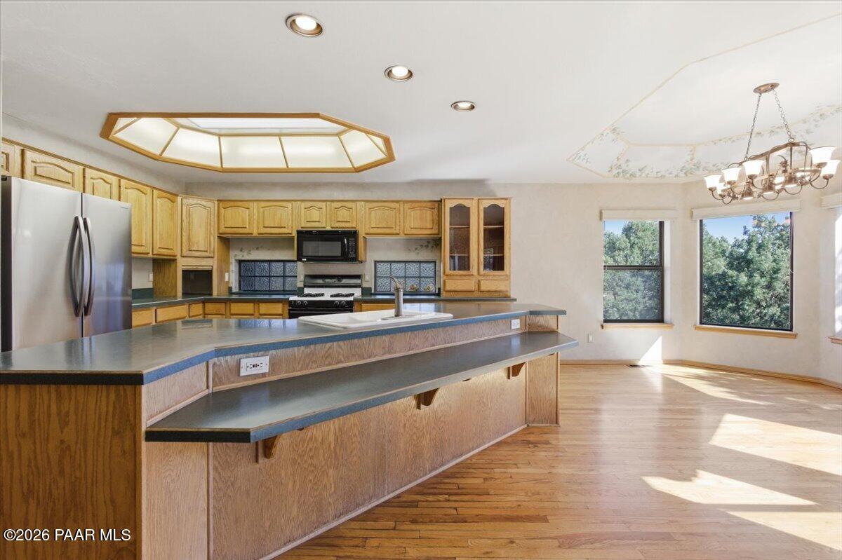 2101 Meander Prescott, AZ 86305 - Photo 6 of 22 a large kitchen with stainless steel appliances a large counter top a stove and a refrigerator