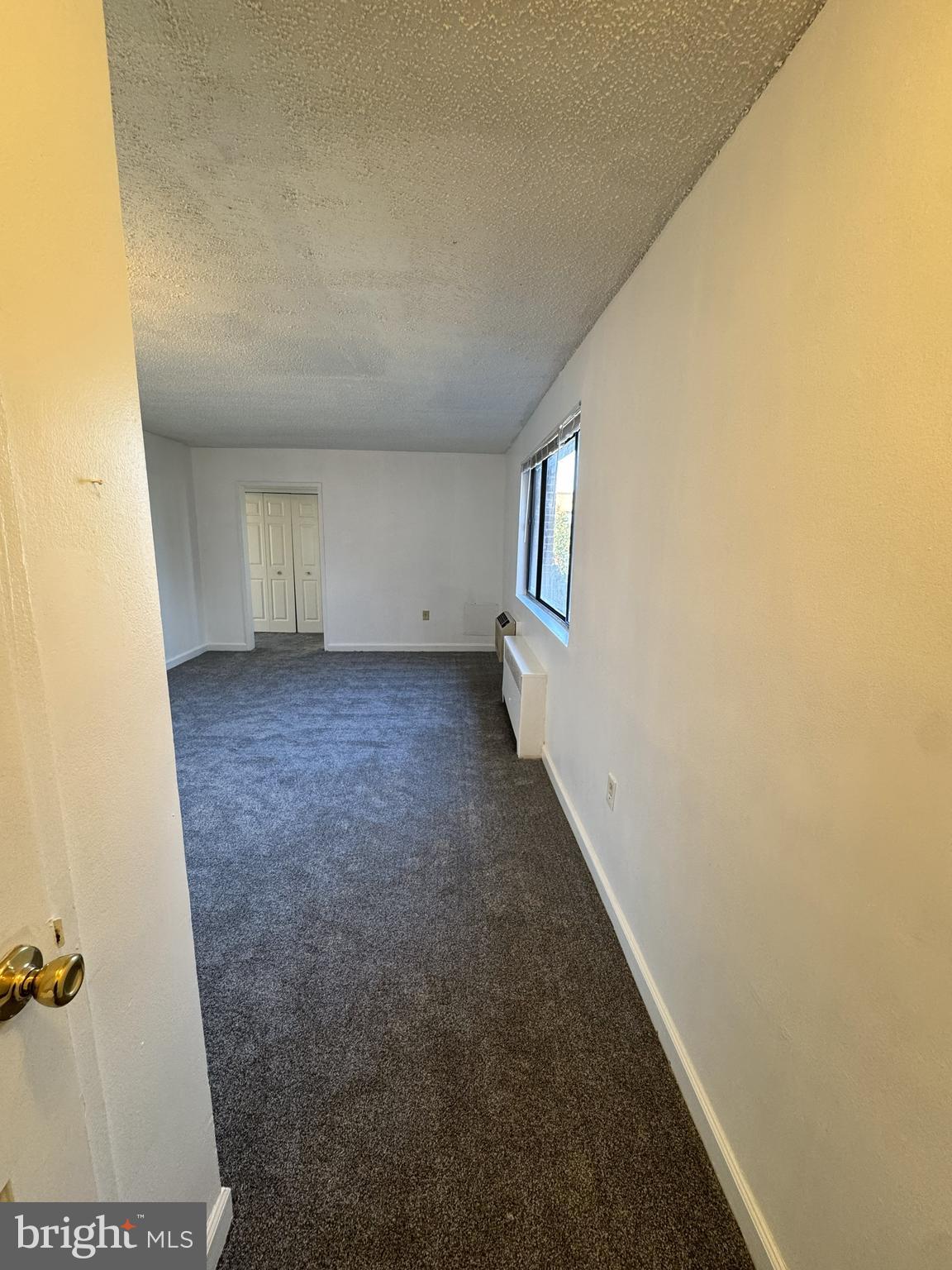 4717 1st Street Southwest, Unit 303 Washington, DC 20032 - Photo 2 of 8 a view of an empty room with a window