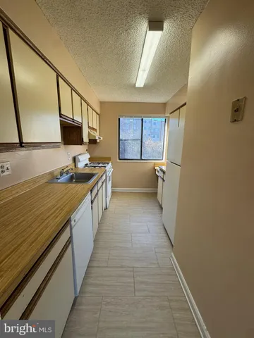 a kitchen with stainless steel appliances a sink and cabinets