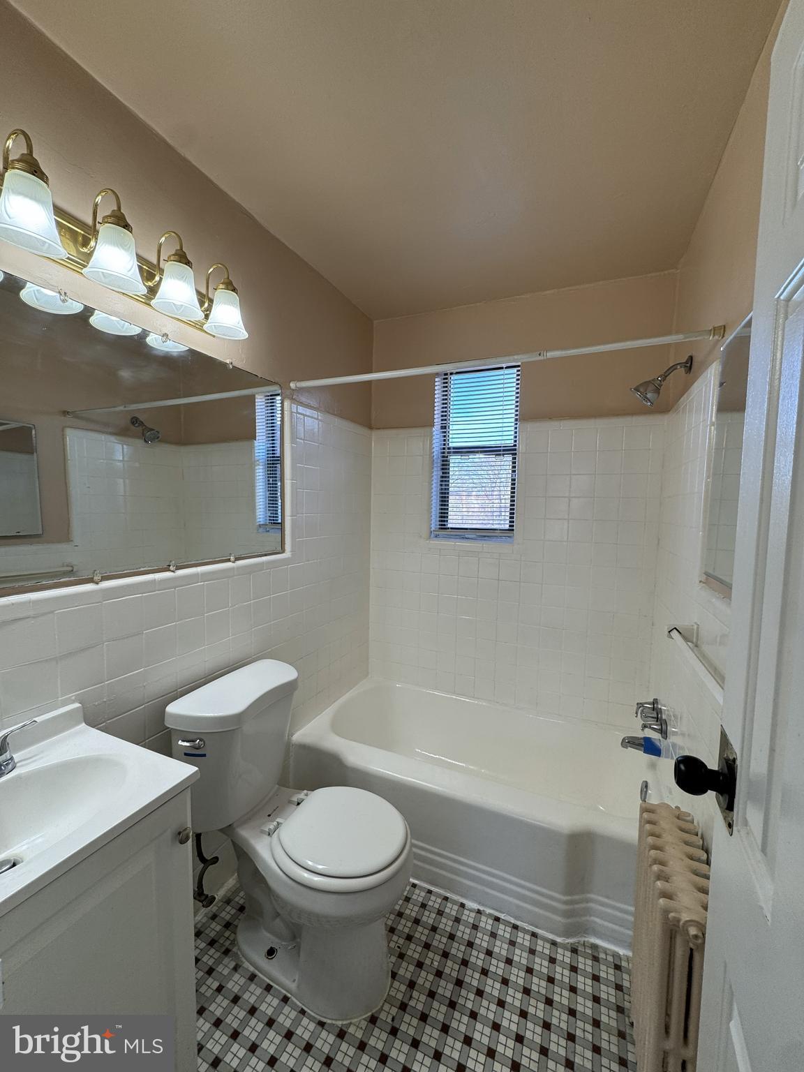 4717 1st Street Southwest, Unit 303 Washington, DC 20032 - Photo 6 of 8 a bathroom with a toilet a sink and bathtub