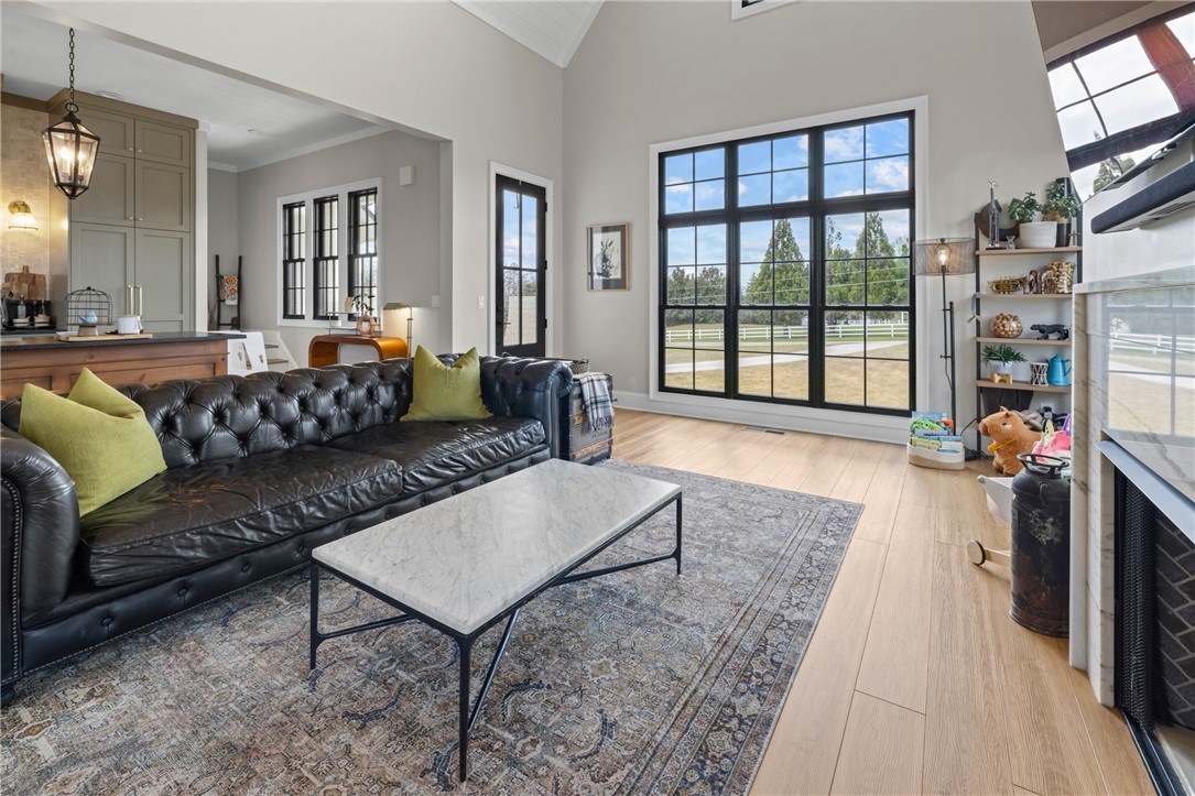 677 Lightwood Road Hartwell, GA 30643 - Photo 6 of 42 This bright living area features vaulted ceilings and expansive windows, offering abundant natural light and scenic views.