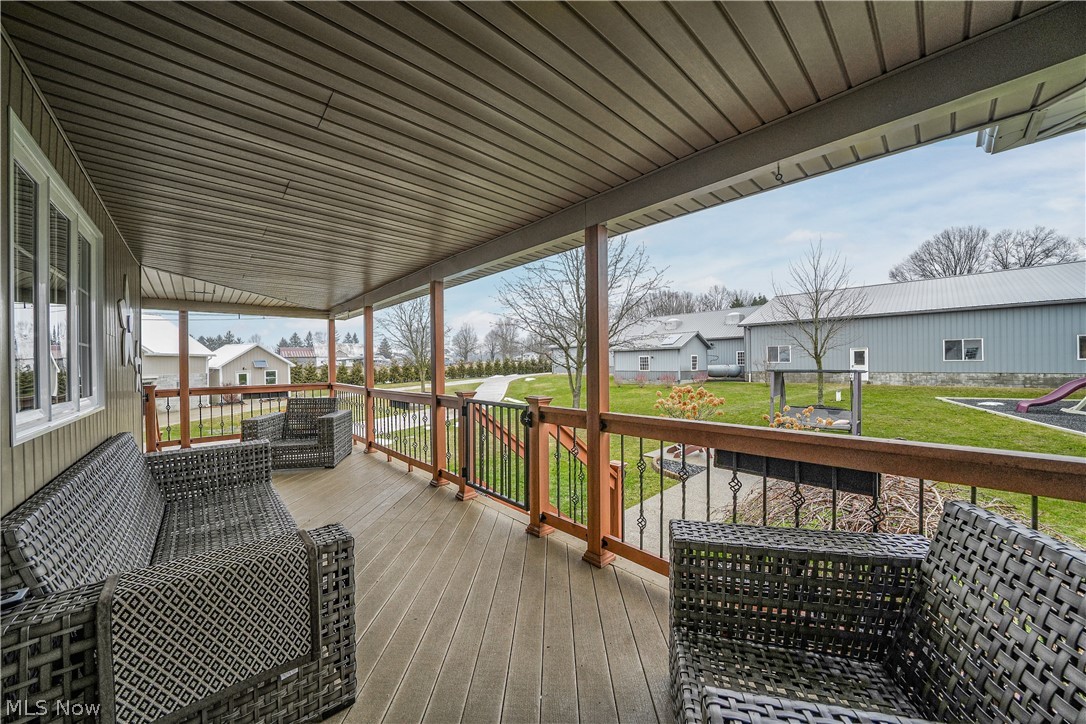 9561 Creaser Road North Bloomfield, OH 44450 - Photo 20 of 45 Wooden terrace featuring a residential view and a yard