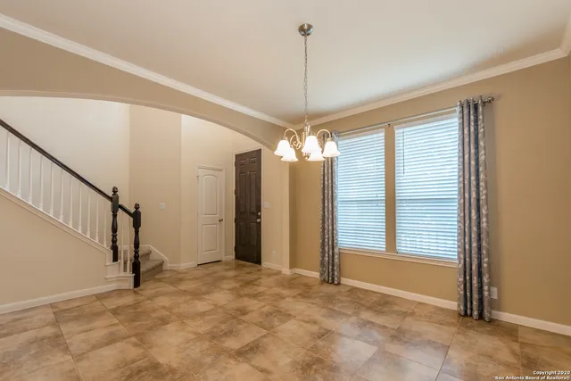 a view of a livingroom with a chandelier fan and window