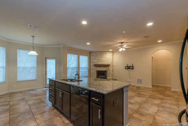 a spacious bathroom with a granite countertop sink a mirror and shower
