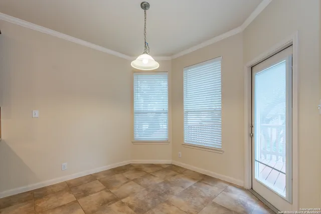 a view of an empty room with a window and fireplace