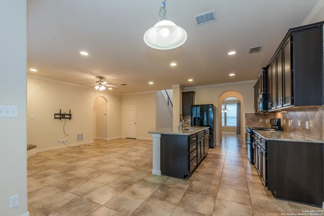 a kitchen with stainless steel appliances granite countertop a sink and a stove