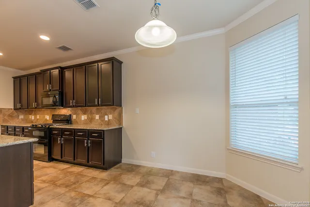 a view of a livingroom with a ceiling fan fireplace and a window