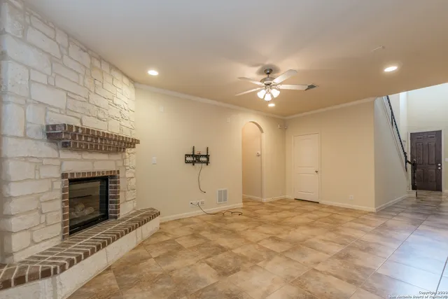 a view of a kitchen with kitchen island a sink stainless steel appliances and a counter top space