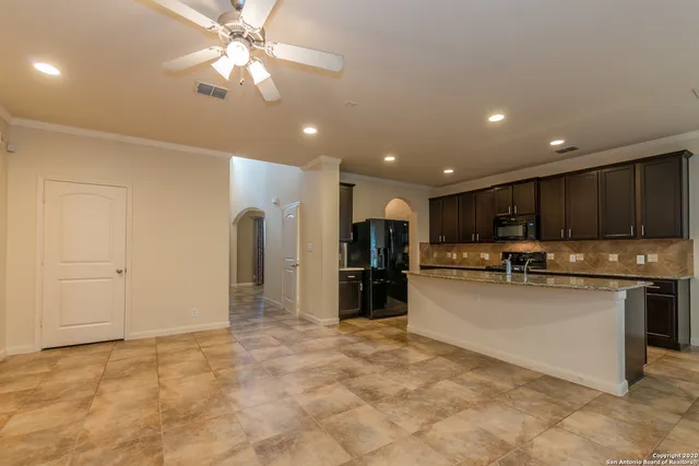 a view of an empty room with a fireplace and a window
