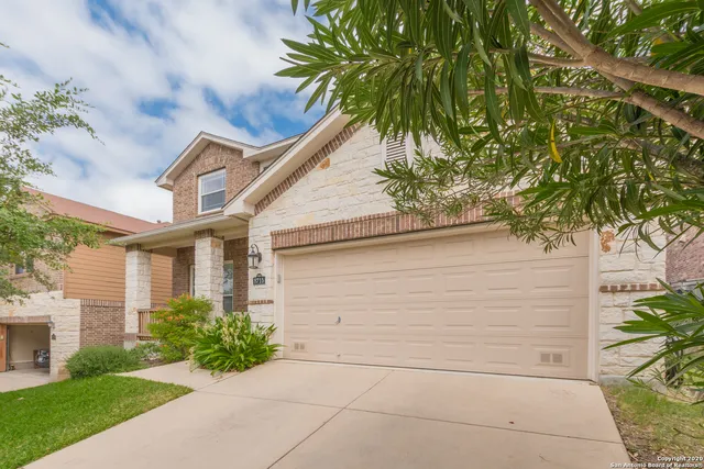 a house that has a tree in front of the house