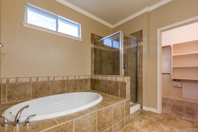 a spacious bathroom with a toilet sink and mirror