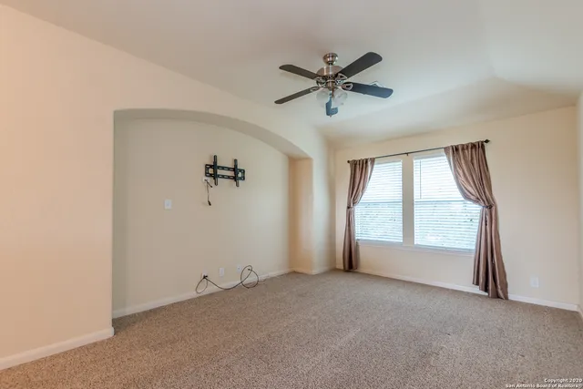 a view of empty room with ceiling fan