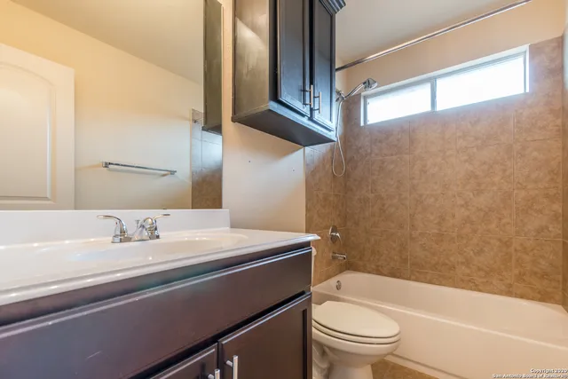 an empty room with closet and a chandelier fan