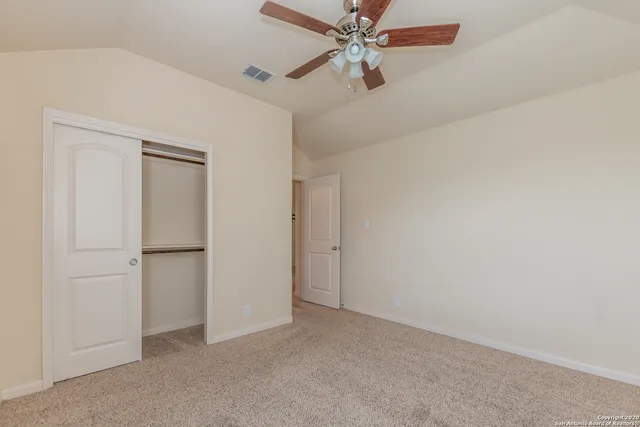 a view of room with a ceiling fan and window