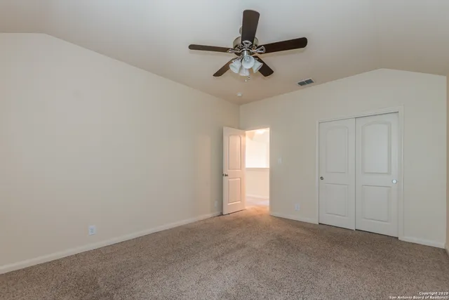a balcony with wooden floor and fence next to a yard