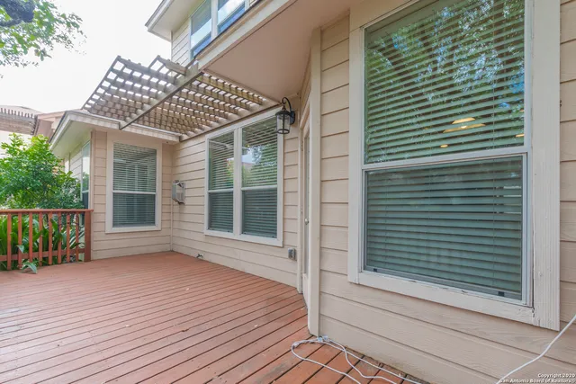a view of a yard in front of a house with a tree
