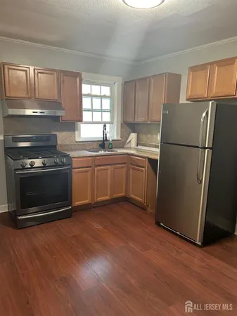 a kitchen with sink a microwave a refrigerator and cabinets