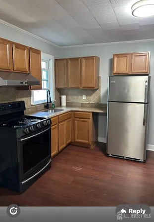 a kitchen with stainless steel appliances granite countertop a stove a refrigerator and a sink