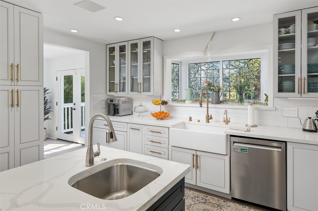 28933 Wagon Road Agoura Hills, CA 91301 - Photo 24 of 73 a kitchen with a sink stove and cabinets