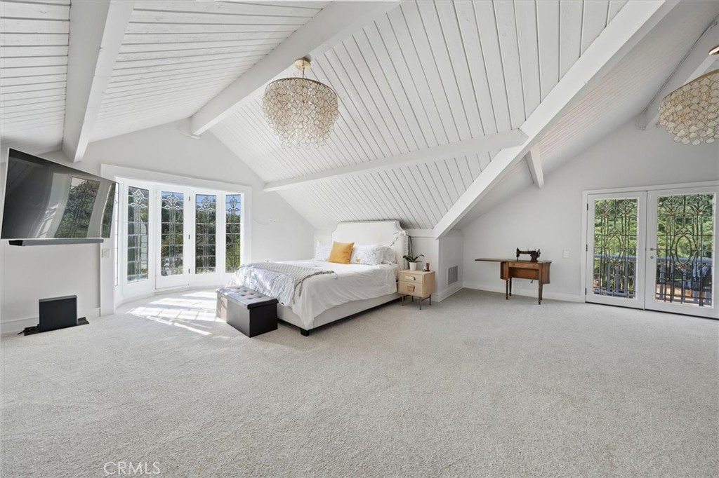 28933 Wagon Road Agoura Hills, CA 91301 - Photo 32 of 73 a spacious bedroom with a bed and a large window