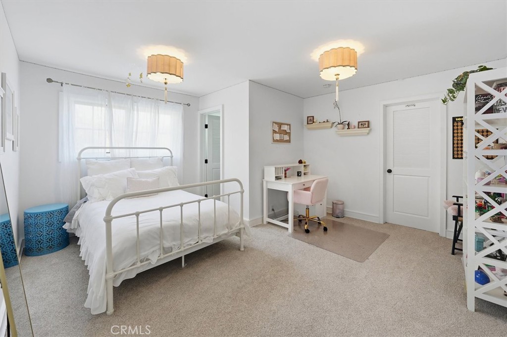 28933 Wagon Road Agoura Hills, CA 91301 - Photo 53 of 73 a bedroom with a bed and a chandelier