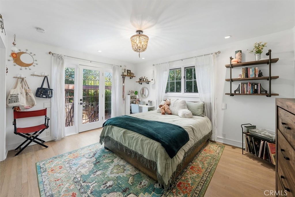 28933 Wagon Road Agoura Hills, CA 91301 - Photo 58 of 73 a spacious bedroom with a bed and a chandelier