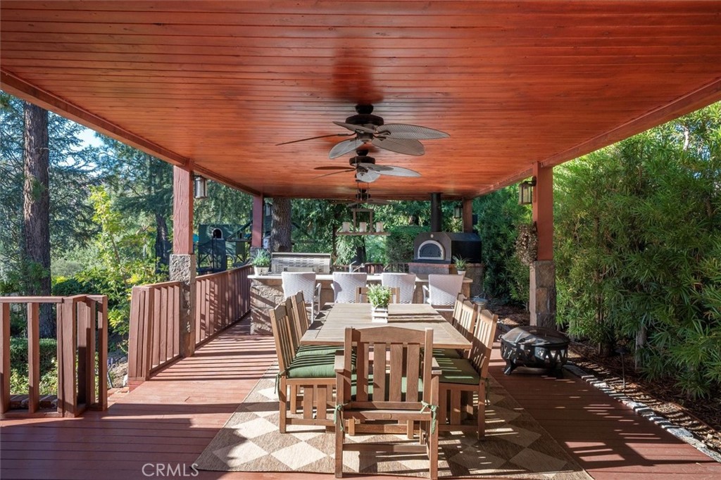28933 Wagon Road Agoura Hills, CA 91301 - Photo 60 of 73 a view of a patio with table and chairs potted plants with wooden floor and floor to ceiling window