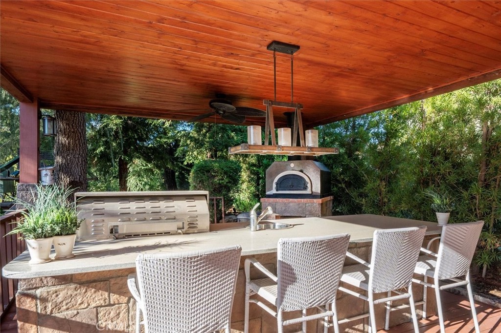 28933 Wagon Road Agoura Hills, CA 91301 - Photo 61 of 73 a view of a patio with a table chairs and a backyard