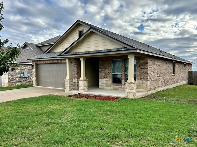 a front view of a house with a yard and porch