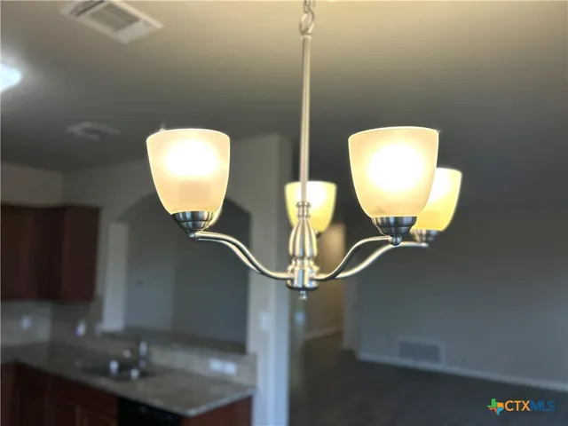 a room with a sink and mirror