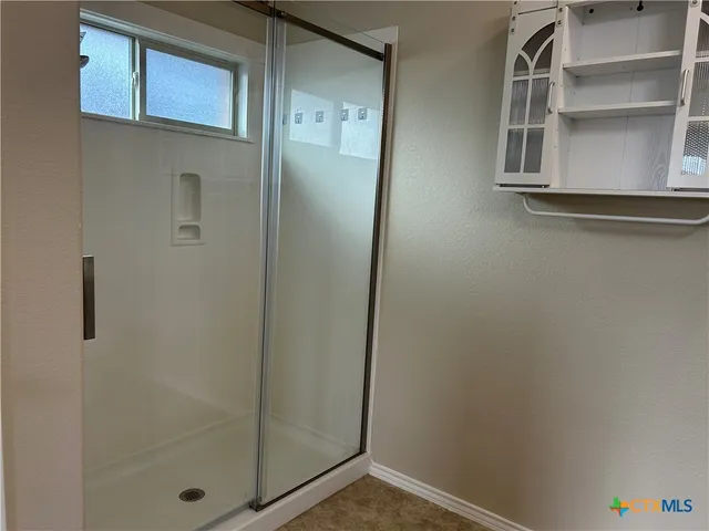 a bathroom with a glass door shower