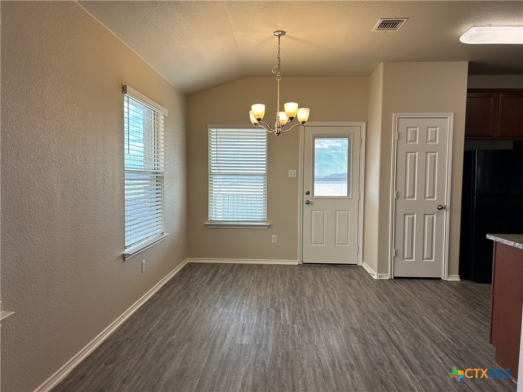 137 Bainbridge Road Temple, TX 76502 - Photo 8 of 26 an empty room with wooden floor and windows