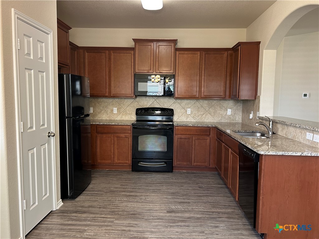 137 Bainbridge Road Temple, TX 76502 - Photo 9 of 26 a kitchen with a sink stove and cabinets