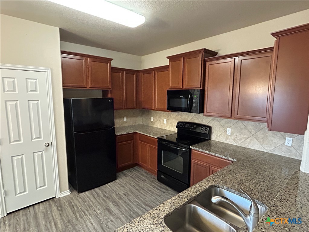 137 Bainbridge Road Temple, TX 76502 - Photo 10 of 26 a kitchen with stainless steel appliances granite countertop a refrigerator stove microwave and sink