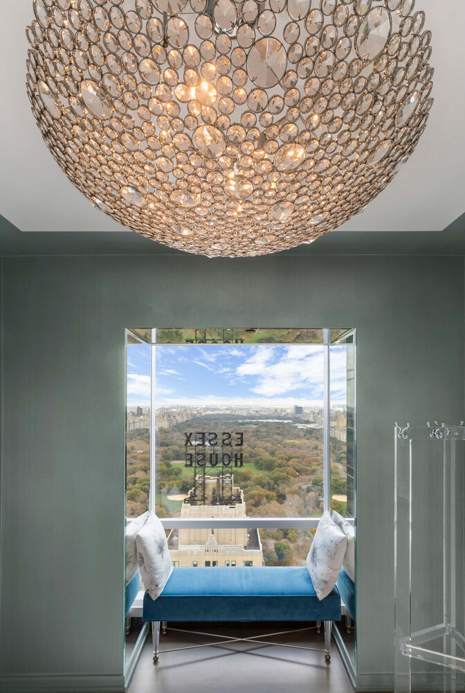 157 West 57th Street, Unit 53B Manhattan, NY 10019 - Photo 18 of 27 a balcony with furniture and a floor to ceiling window