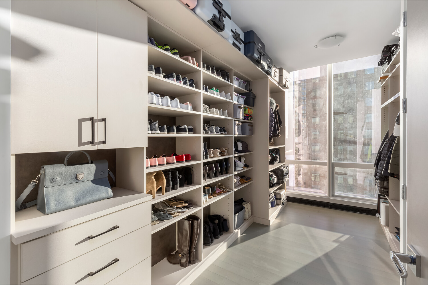 157 West 57th Street, Unit 53B Manhattan, NY 10019 - Photo 22 of 27 a view of walk in closet with clothes and shoes