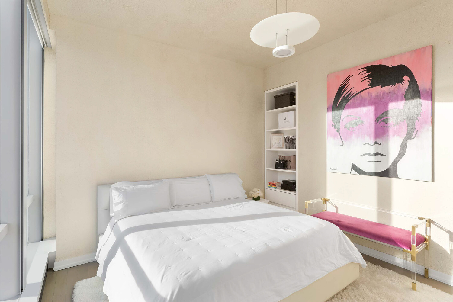 157 West 57th Street, Unit 53B Manhattan, NY 10019 - Photo 23 of 27 a bedroom with a bed and painting on the wall