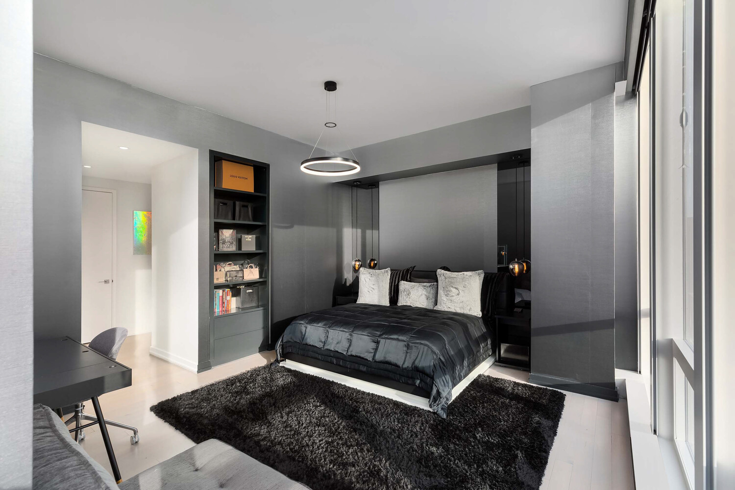 157 West 57th Street, Unit 53B Manhattan, NY 10019 - Photo 24 of 27 a bedroom with a large bed and a chandelier