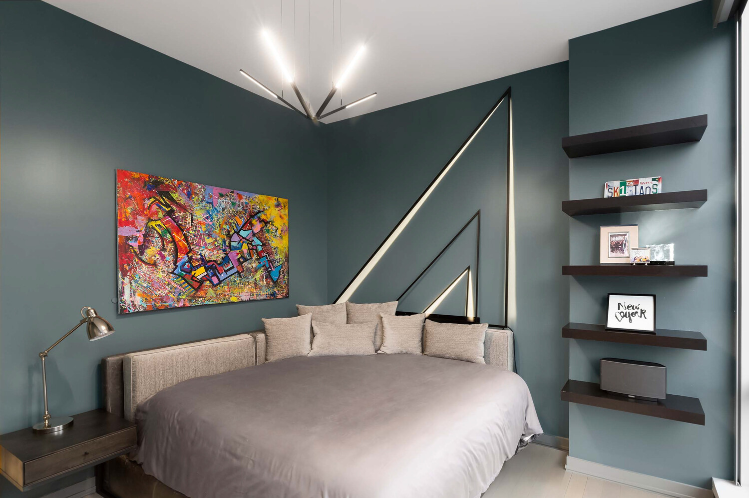 157 West 57th Street, Unit 53B Manhattan, NY 10019 - Photo 26 of 27 a bedroom with a bed and a bookshelf with the potted plants