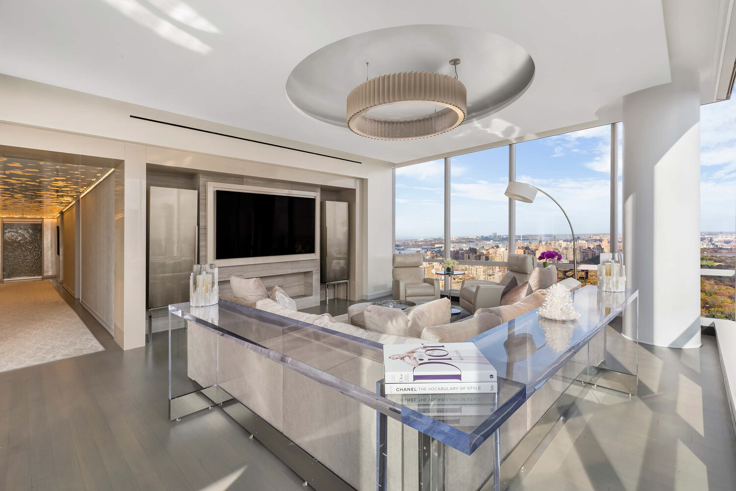 157 West 57th Street, Unit 53B Manhattan, NY 10019 - Photo 5 of 27 a living room with furniture a flat screen tv and a large window