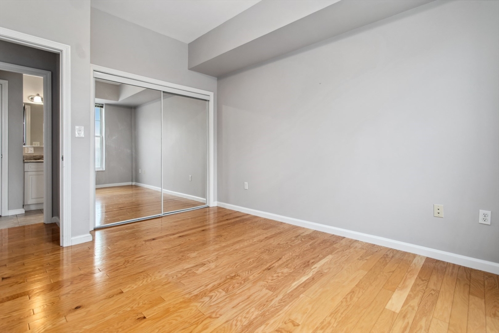 36 Village Road, Unit 404 Middleton, MA 01949 - Photo 26 of 41 a view of an empty room with wooden floor