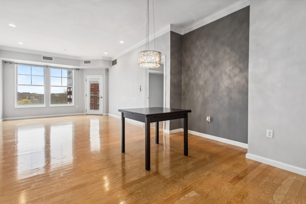 36 Village Road, Unit 404 Middleton, MA 01949 - Photo 4 of 41 a view of an empty room with window and wooden floor
