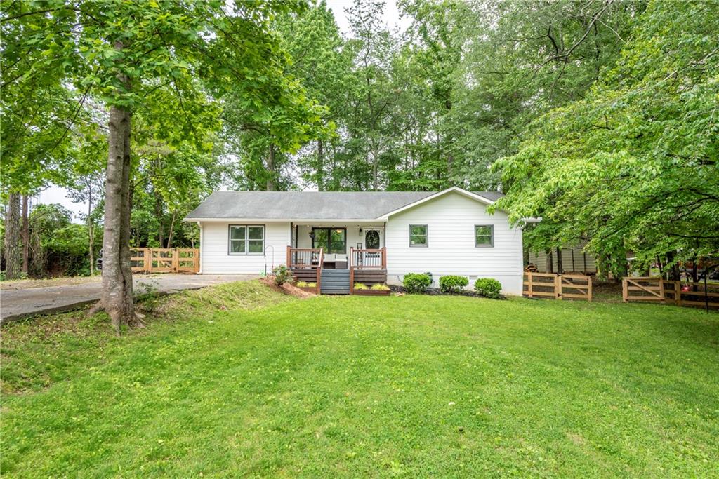 795 Pioneer Road Jasper, GA 30143 - Photo 1 of 1 a front view of a house with a garden and trees