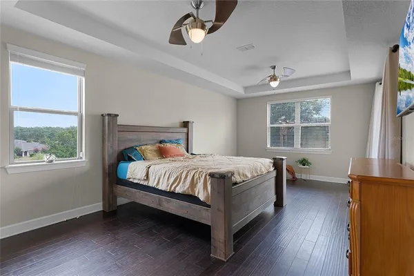 a bed sitting in a bedroom next to a window